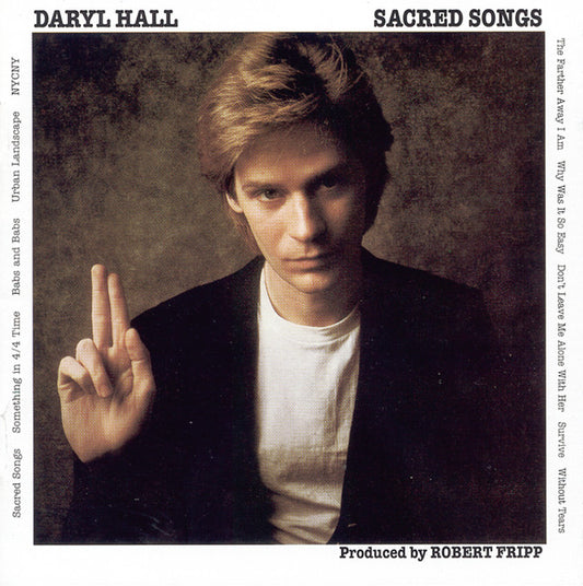 CD cover art featuring a photo of Daryl Hall with his middle finger extended, album title 'Sacred Songs', and tracklist.